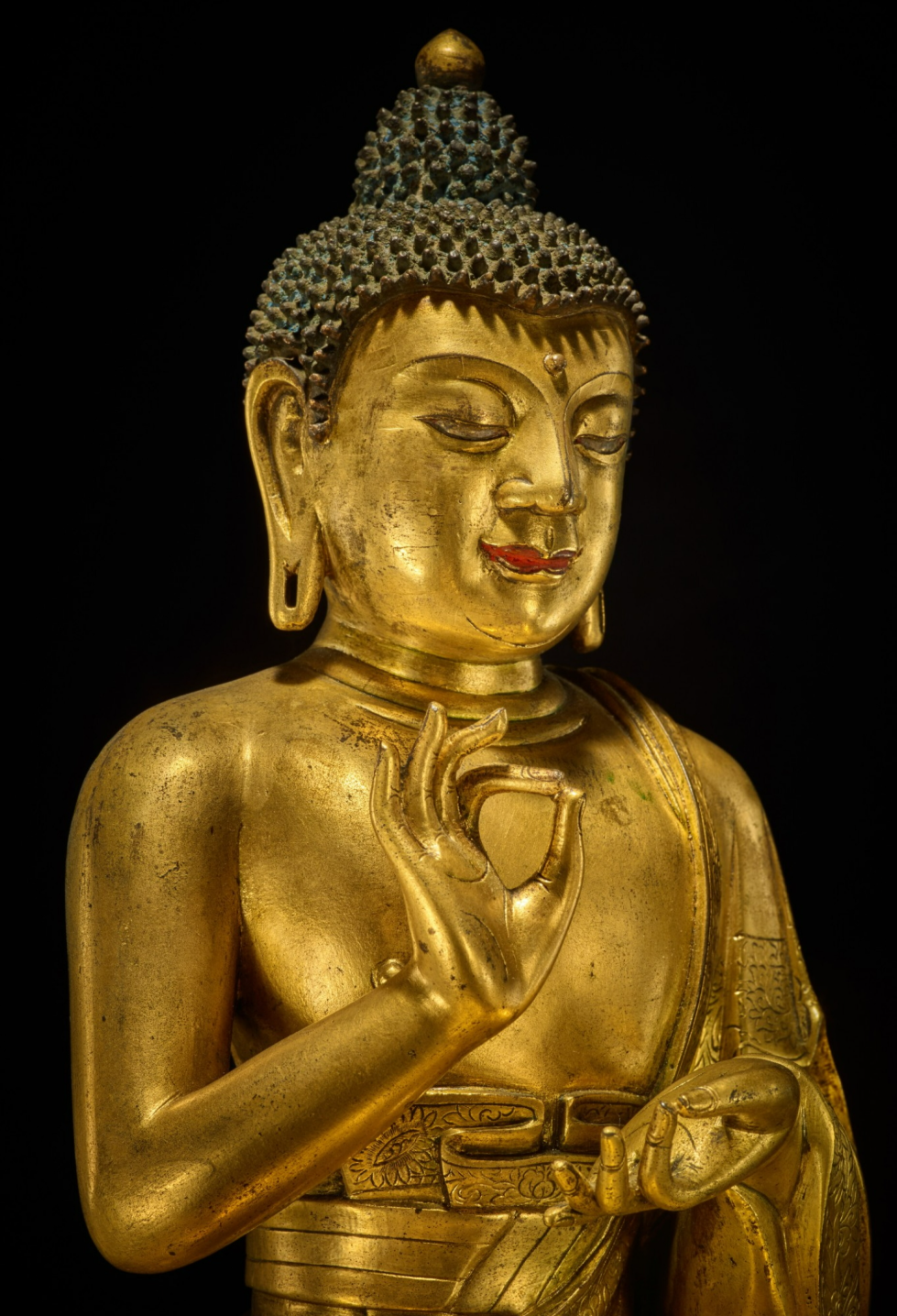 Detail of a gilt bronze figure of Dipankara Buddha in the vitarka mudra