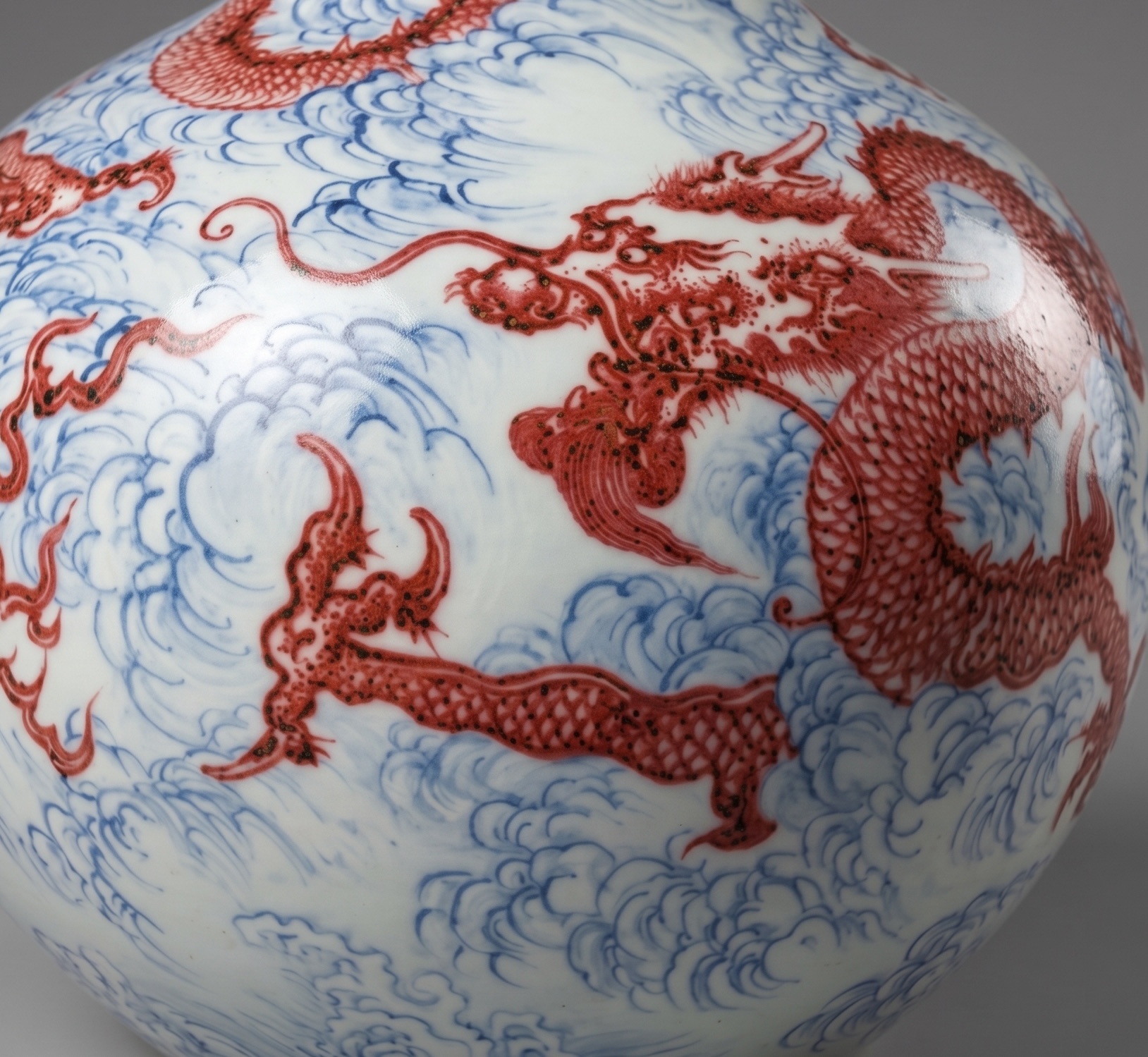 Detail of a Chinese porcelain vase with underglaze-blue clouds and copper-red dragons