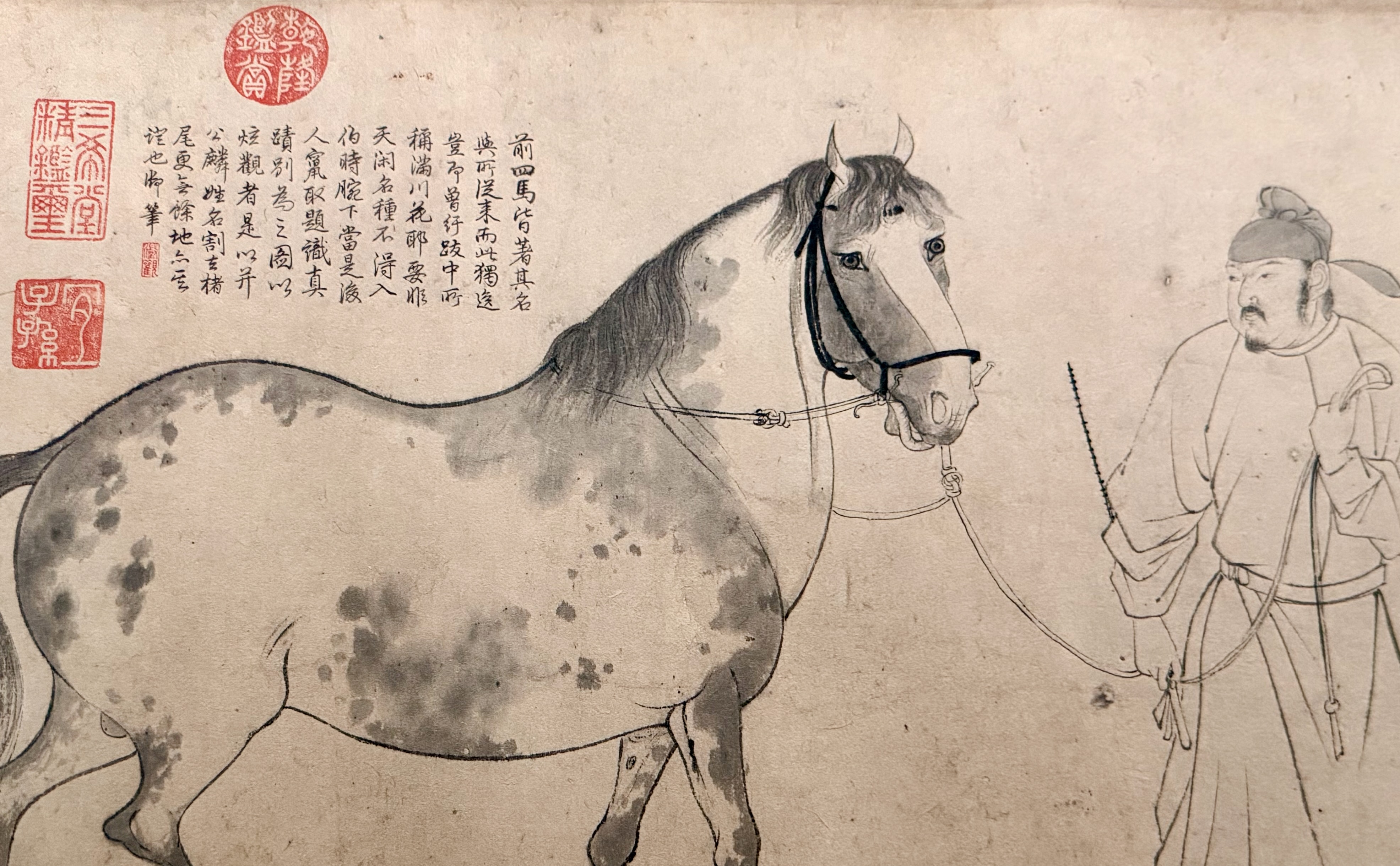A classical Chinese ink painting of a dappled horse and groom with calligraphy and collector seals